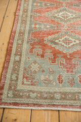Geometric patterns and distressed texture of the vintage Veece runner in ruby red and slate blue.