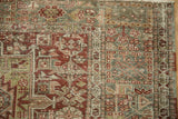 Low-pile texture and geometric serpent border on a distressed vintage Karaja rug corner.