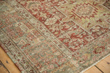 Detailed view of the serpent design motif border and distressed pile on a vintage Karaja rug.