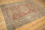 Distressed vintage Karaja rug showing brick red triple medallions and time-softened green tones.