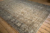 Angled view of a vintage Mehrivan carpet's corner with a charcoal Turtle Samovar border.