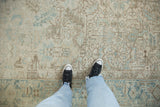 A view of the heavy abrashes and low-pile texture on a vintage distressed Mehrivan carpet.