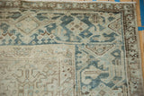 Worn, low-pile texture on the geometric Turtle Samovar border of a vintage Mehrivan carpet.