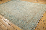 Angled view of a vintage Mehrivan rug highlighting the heavy abrashes and soft, time-softened colors.