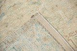 Back of the vintage Persian rug showing its hand-knotted construction and restored side cord.