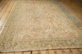 Low angle view across the distressed vintage Mehrivan carpet, showing the allover geometric floral pattern.