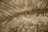 Softly worn texture of a vintage Persian rug with visible coffee brown and slate blue knot heads.