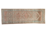 Vintage distressed Serab runner featuring geometric medallion, muted rose, beige, and blue, 3'6