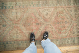 Textured surface of distressed Serab runner featuring geometric medallion and pawn motifs.