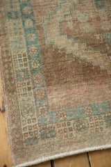 Distressed Serab rug corner detail, showing geometric pawn motif and pale blue accents with wear.