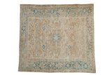 Distressed vintage Heriz square carpet with allover beige field and dusty blue motifs.