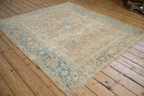 Vintage Distressed Heriz carpet corner with dusty blue and beige turtle motif border.