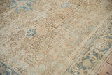 Patinaed vintage Heriz carpet texture, with faded beige field and dusty blue blossoms.