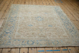 Distressed vintage Heriz carpet border, showing dusty blue inverted samovar turtle design.