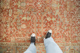 The distressed, low-pile texture and pattern scale of a vintage Persian Heriz carpet.
