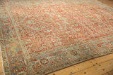 Worn ruby red field and intricate Samovar Turtle border of a vintage Persian Heriz rug.