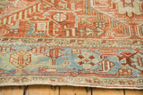 Low-pile texture of the Samovar Turtle border and ruby red field on a distressed Heriz rug.
