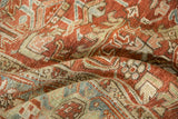 Gentle folds showing the even wear and low-pile texture of a distressed vintage Heriz carpet.