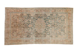 Distressed vintage Hamadan runner with a center medallion and floral sprays in dusty teal, coral, and sand.