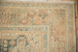 Evenly worn pile on a vintage Hamadan rug with floral motifs in dusty teal and pale coral.