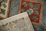 Hand-knotted back and secured side cord of the distressed Persian Afshar rug.