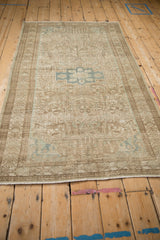Angled view of a distressed Mehriban rug showing its decorative, time-softened neutral palette.