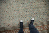 Time-softened texture and even wear on a vintage Tabriz carpet with a dusty teal and rust Herati pattern.