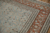 Intricate rust turtle samovar border contrasting with the dusty blue Herati field on a distressed Tabriz.