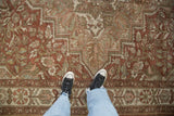 Close view of the distressed texture and stepped geometric design of a vintage Baktiari rug.