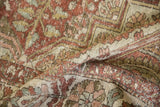 The soft, low pile of a distressed Baktiari carpet showing visible knot heads and time-softened hues.