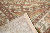 The hand-knotted back and restored side selvage of a vintage distressed Baktiari carpet.