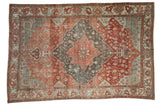 Distressed vintage Baktiari carpet, red and dusty teal floral field, dark diamond medallion.