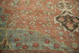 Distressed Baktiari carpet detail showing heavy abrashes, interconnecting blossoms, dusty teal corner.