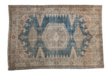 Vintage distressed Veece carpet with a hexagonal medallion and geometric patterns in dusty blue, beige, and rose.