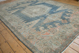 Angled view of the distressed Persian Veece carpet's low pile and meandering border.