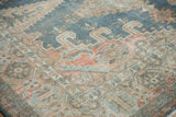 Meandering pomegranate vine border on a distressed Persian Veece rug with low-pile texture.