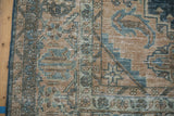 Detailed view of the vintage carpet's distressed pile with mostly even wear to the knot heads.