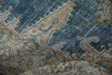 Textured weave of a distressed Persian rug showing wear to knot heads in dusty blue.