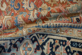 Folded Gorevan carpet detail: serrated leaves, Turtle Samovar border, brick red, and navy blue.