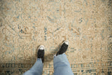Distressed Heriz carpet pile showing even wear and geometric motifs in dusty blue and pale brown.
