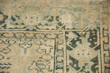 The vintage Heriz carpet's Turtle Samovar border, showing wear down to the knot heads.
