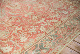 Angled perspective of a vintage Heriz carpet showing the low pile and traditional pattern wear.