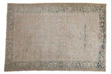 Distressed Heriz carpet, allover faded beige and dusty blue floral pattern, with visible foundation.