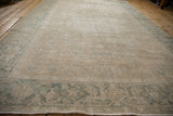 Low pile texture on a distressed Heriz carpet, showcasing dusty teal Turtle Samovar border and floral field.