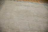 Textured distressed vintage Heriz field: faded beige with mostly even wear and dusty blue floral motifs.