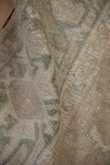Muted floral design and pile texture with mostly even wear on a vintage Heriz carpet.