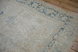 Distressed Mehrivan carpet's faded floral field and dusty sapphire Turtle Samovar border.