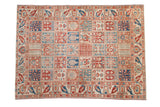 Vintage Baktiari carpet with a distressed panel design in cherry red, sapphire blue, and ivory tones.