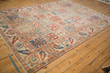 Angled perspective on the allover panel field of a distressed Baktiari carpet.