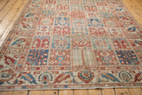 View across the paneled field of a distressed Baktiari carpet, showing its even, low-pile texture.